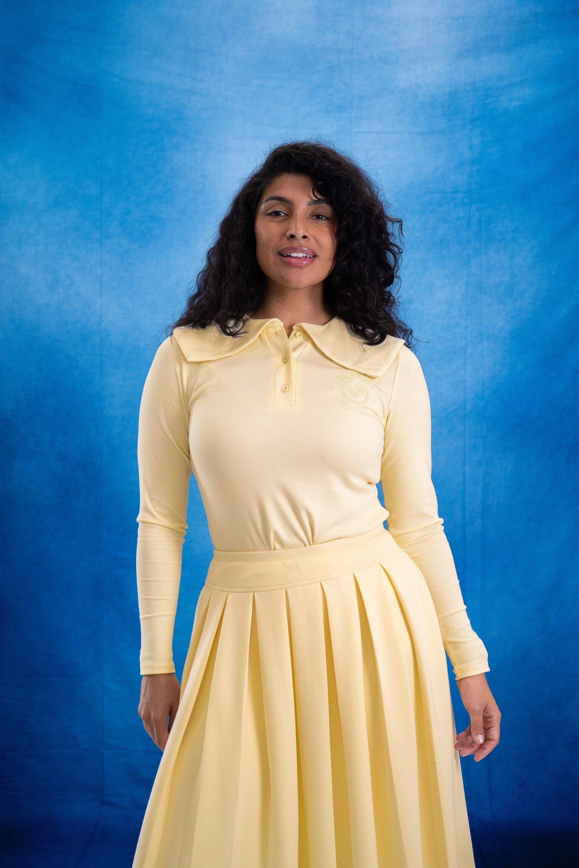 Woman wearing a yellow dress against a blue background