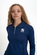 Person wearing a navy blue pullover with a logo on a white background