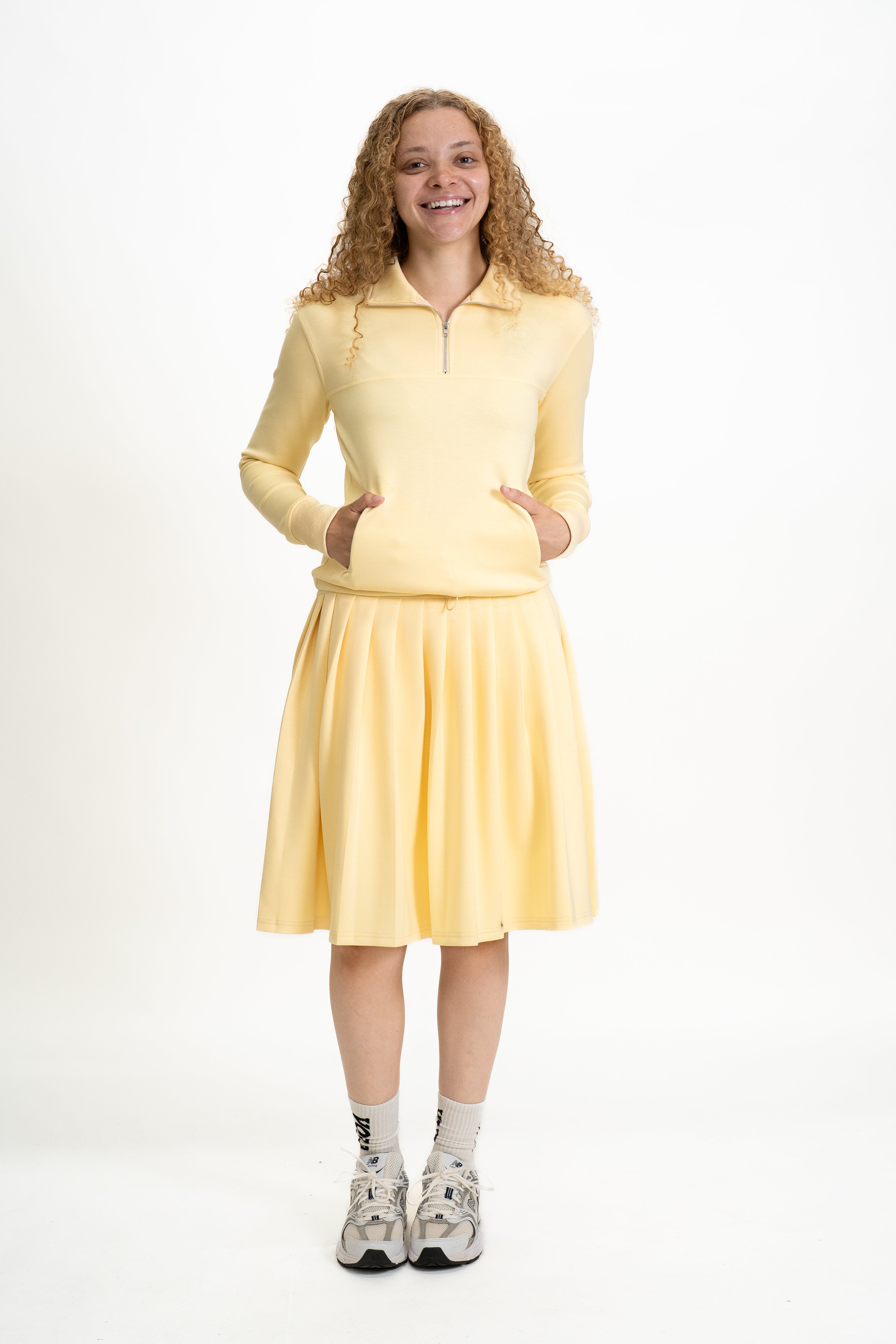 Woman wearing a yellow outfit on a white background