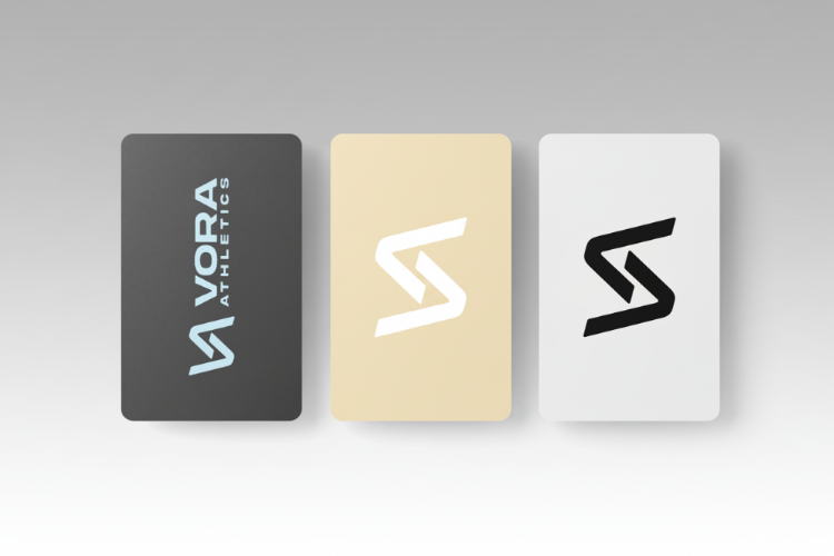 Three rectangular cards with different VORA logos on a gray background.